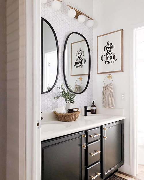 one light fixture over two mirrors