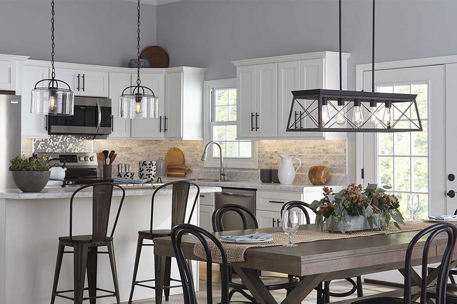 farmhouse style kitchen and dining room with farmhouse chandelier over dining table